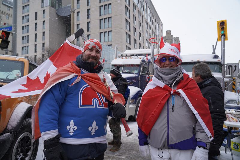 Two people pose for a picture while attending the anti-vaccine protest in Ottawa. Willy Lowry / The National.