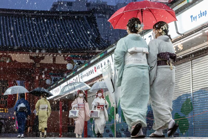 Women wearing kimonos shelter under umbrellas during heavy snowfall in Asakusa, central Tokyo. Roads were closed in Japan's capital due to the snow. Getty Images