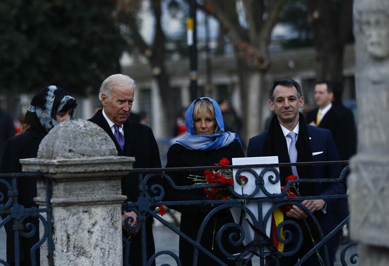 US Vice President Joe Biden (2nd L) flanked by his wife Jill (2nd R), his granddaughter Naomi Biden (L), and son-in-law Howard Krein (R) pays tribute on January 22, 2016 in Istanbul,  to the victims of the January 12 bomb attack, where ten German tourists were killed, in the historic Sultanahmet district of Istanbul. - US Vice President Joe Biden strongly criticised Turkey for failing to set the right "example" on freedom of expression, slamming the imprisonment of journalists and investigation of academics who criticised government policy. (Photo by Murad SEZER / POOL / AFP)