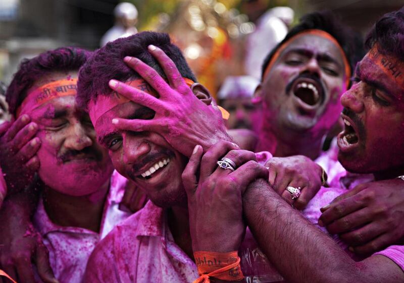 A Hindu devotee smears the face of another with coloured powder on September 15, 2016, during a procession for the immersion of idols of elephant-headed Hindu god Ganesha in the River Tawi on the final day of the 10-day Ganesh Chaturthi festival in Jammu, India. The crowds sing and dance as they carry their idols to immerse them in the water, an act that symbolises sending the god back to his mythical home in the snow-capped mountains, taking the worries and problems of his worshippers with him. Channi Anand / Associated Press
