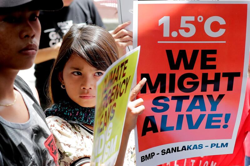 Environmental activists hold placards during a rally outside the Department of Environment and Natural Resources at suburban Quezon city, northeast of Manila, Philippines. AP Photo