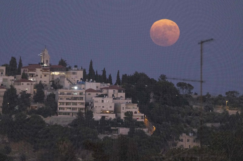 The sturgeon supermoon rises above the Mount of the Olives in Jerusalem. AFP