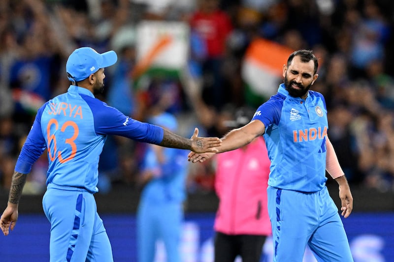India's Mohammed Shami, right, celebrates taking the wicket of Zimbabwe's Tony Munyonga with teammate Suryakumar Yadav. AFP