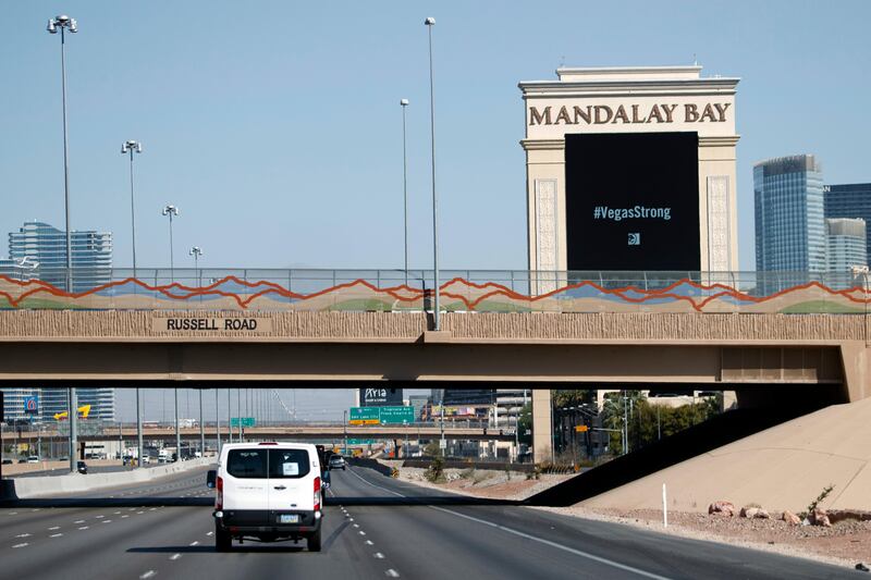 President Donald Trump's motorcade passes the Mandalay Bay Resort and Casino on the way to meet with victims and first responders of the mass shooting. Evan Vucci / AP Photo