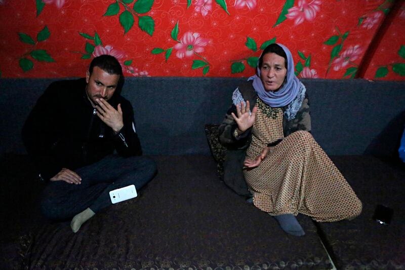 Baseh Hammo, a Yazidi woman who escaped ISIS enslavement, sits with a relative in a camp for displaced people outside Dahuk, Iraq. AP Photo