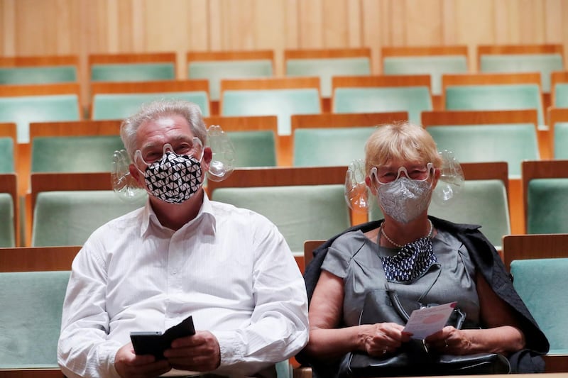 A couple wears orchestra conductor Ivan Fischer's acoustic mask at the Mupa Budapest in Budapest, Hungary, September 11, 2020. Picture taken September 11, 2020. REUTERS/Bernadett Szabo