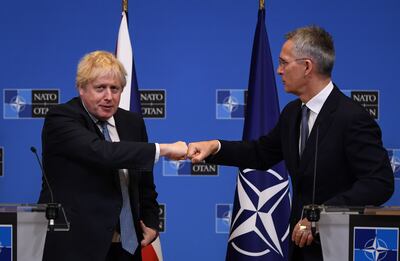 British Prime Minister Boris Johnson gives a fist bump to Nato Secretary General Jens Stoltenberg at a joint press conference in Brussels. The pair held talks on the military alliance's response to Russia's aggression towards Ukraine. (Photo by Daniel Leal - Pool  / Getty Images)