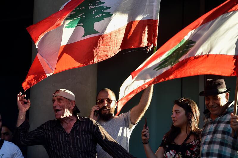 Lebanese protesters shout slogans during a demonstration against the high cost of telecoms, the high cost of living and the low purchasing power of the Lebanese pound in front of the MTC Touch communications building in Beirut, Lebanon. EPA