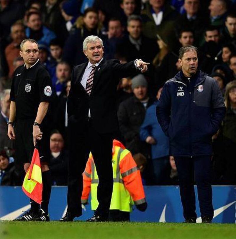 Stoke manager Mark Hughes, centre, gestures as he speaks to the linesman during the FA Cup fifth round match against Blackburn Rovers at Ewood Park on February 14, 2015 in Blackburn, England. (Photo by Stu Forster/Getty Images)