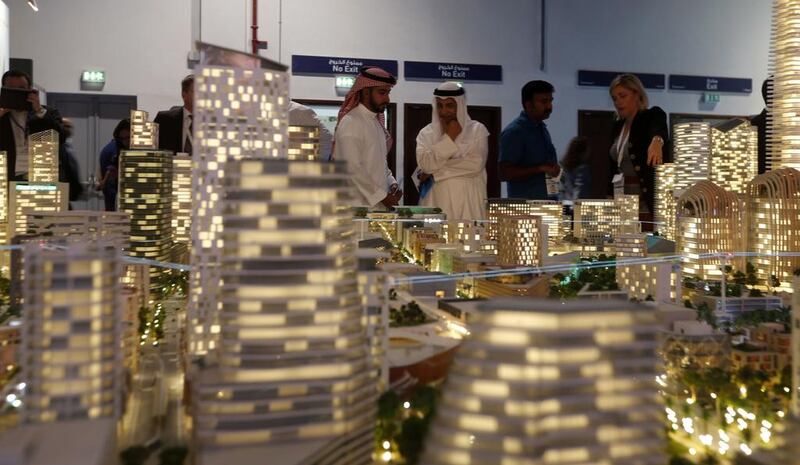 Visitors gather near a scaled version of a property project durign the Cityscape Global 2016 show in Dubai last month. Karim Sahib / AFP