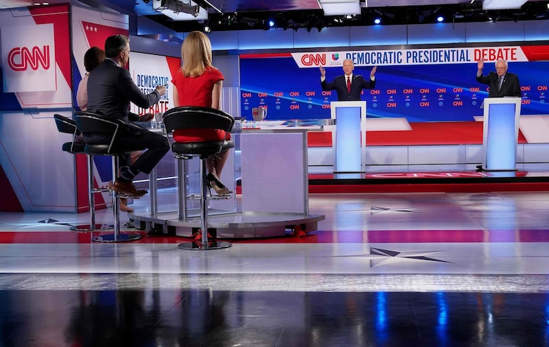 Moderators Univision's journalist Ilia Calderon, hidden, CNN chief Washington correspondent Jake Tapper and CNN political correspondent Dana Bash listen. AFP