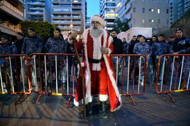 A demonstrator dressed in a Santa Claus costume stands outside the Beirut home of Hassan Diab on December 24  in protest at his nomination as Prime Minister of Lebanon. Mr Diab vowed on 19 December to form a government of experts within six weeks. EPA