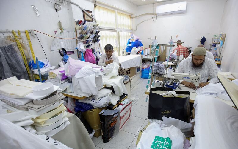 Among piles of fabric, tailors get to work with pin-point precision. 
