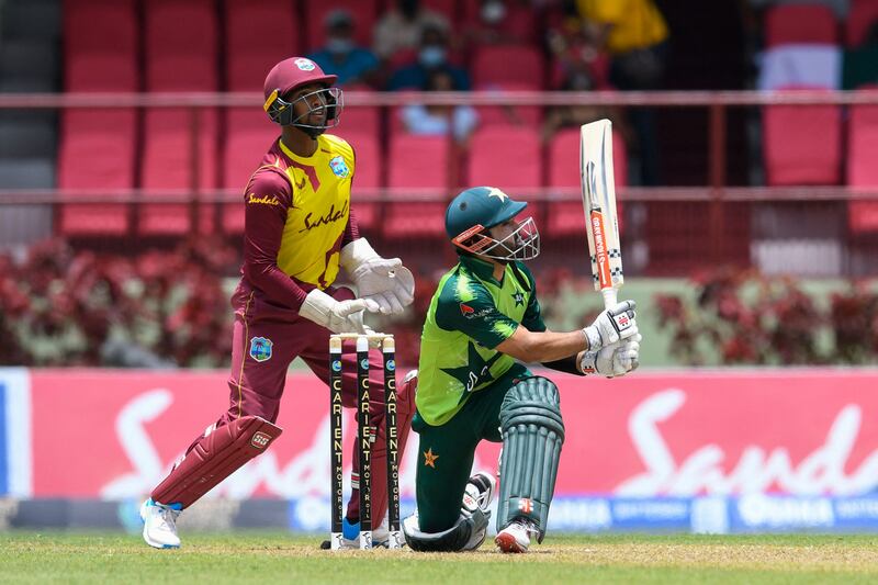 Mohammad Rizwan of Pakistan hits a six as Nicholas Pooran looks on during the second T20 against the West Indies at Guyana National Stadium in Providence on Saturday, July 31, 2021.