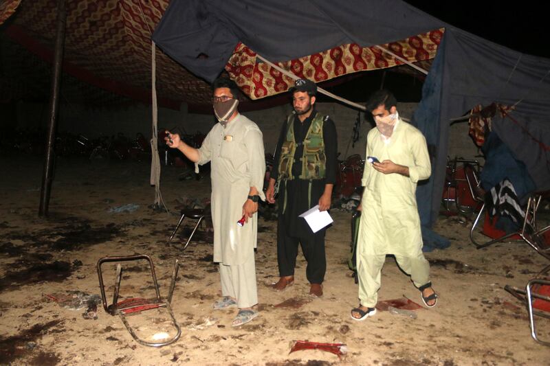 People survey the site of a blast targeting a gathering of hardline political party Jamiat Ulma-e-Islam-Fazl in Bajaur, Pakistan on Sunday. EPA