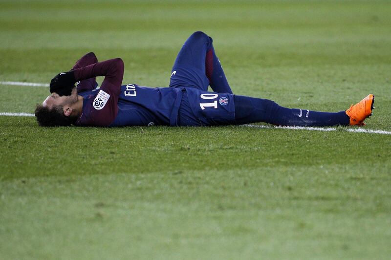 (FILES) In this file photo taken on February 25, 2018 Paris Saint-Germain's Brazilian forward Neymar Jr reacts lying on the pitch during the French L1 football match between Paris Saint-Germain (PSG) and Marseille (OM) at the Parc des Princes in Paris.
On February 28, 2018 Paris Saint-Germain said Brazilian superstar Neymar, the world's most expensive footballer, will undergo surgery on his foot and ankle injury in Brazil at the end of the week. / AFP PHOTO / GEOFFROY VAN DER HASSELT