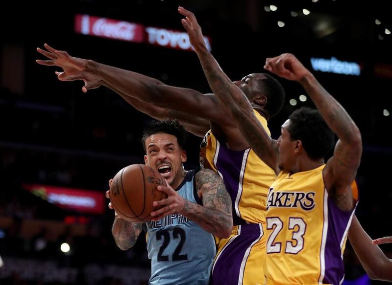 Matt Barnes, #22 of the Memphis Grizzlies, drives to the basket against Louis Williams #23 and Brandon Bass, #2 of the Los Angeles Lakers, during the second half of a game at the Staples Center in Los Angeles, California. Sean M. Haffey / Getty Images / AFP