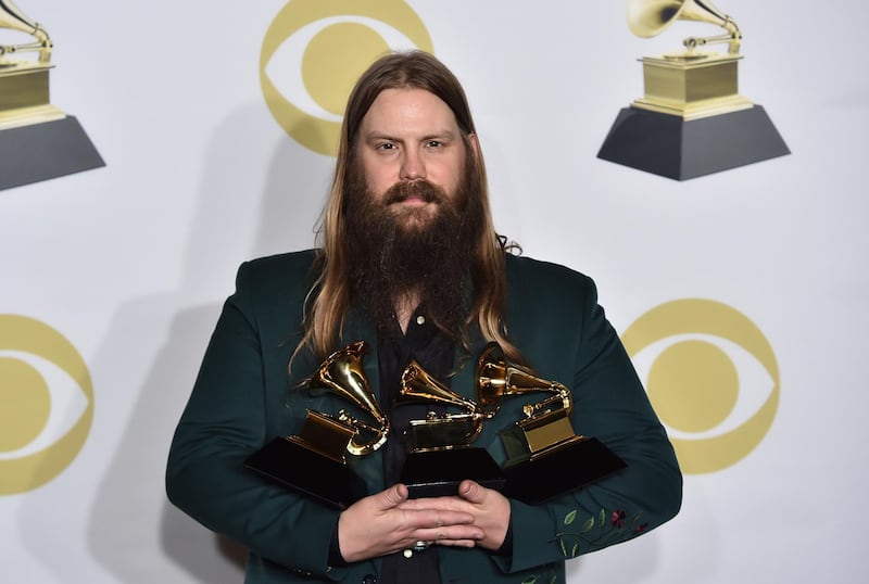 Chris Stapleton poses in the press room with his awards for best country solo performance for "Either Way", best country song for "Broken Halos" and best country album for "From a Room: Volume 1" at the 60th annual Grammy Awards. Charles Sykes / Invision / AP