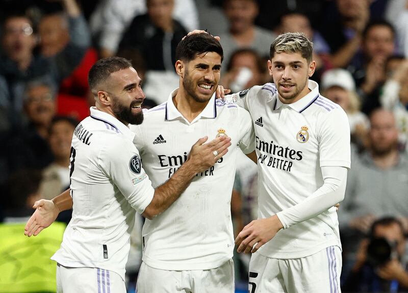 Real Madrid's Marco Asensio celebrates scoring their third goal with Dani Carvajal and Federico Valverde. Reuters