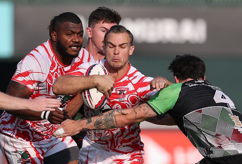 Dubai Tigers (red and white) beat Abu Dhabi Harlequins in the Gulf Men's final at the Dubai Rugby Sevens. All images Chris Whiteoak / The National