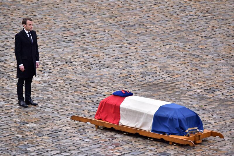 epaselect epa06634003 French President Emmanuel Macron stands in front of the flag-draped coffin of the Gendarme Lieutenant-Colonel  Arnaud Beltrame during a solemn funeral ceremony, in the courtyard of the Invalides in Paris, France, 28 March 2018. Beltrame was killed after swapping himself in exchange of a female hostage during a terrorist attack in Trebes, southern France, on 23 March 2018.  EPA/CHRISTOPHE PETIT TESSON  EPA-EFE/CHRISTOPHE PETIT TESSON