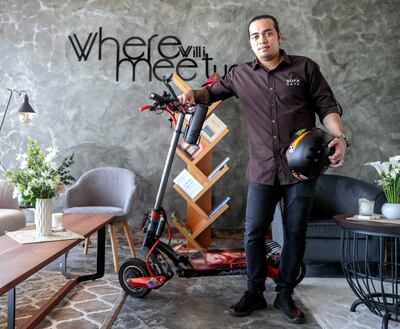 Abu Dhabi, United Arab Emirates, August 14, 2019.  E-scooter barista, Sam Soliguen with his Zero 10X scooter at the Sala Cafe, Abu Dhabi.
Victor Besa/The National
Section:  NA
Reporter:  Haneen Dajani