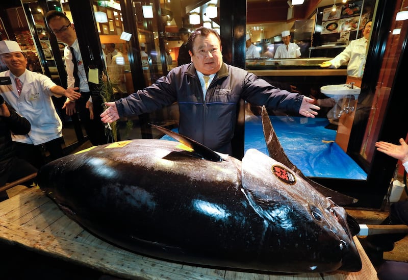 Kiyoshi Kimura, President of Japanese sushi chain Sushi-Zanmai, shows off his 275kg bluefin tuna at the first auction of the new year at Toyosu Market in Tokyo. EPA