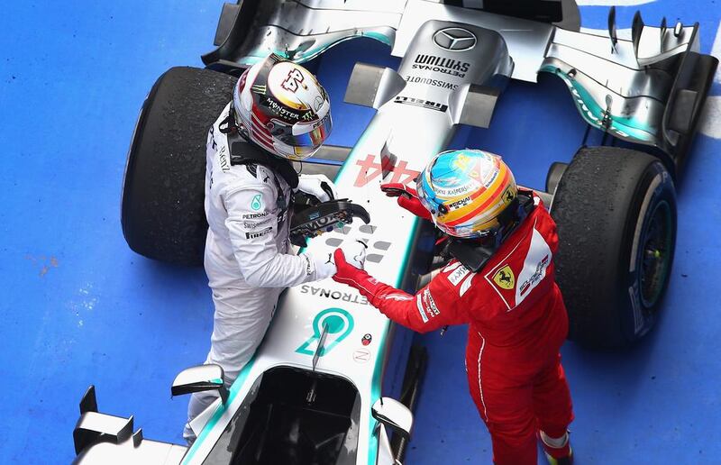 Lewis Hamilton of Mercedes-GP is congratulated by third place finisher Fernando Alonso of Ferrari following the Chinese Grand Prix on Sunday. Clive Mason / Getty Images / April 20, 2014