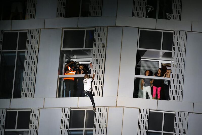 Alain Robert scales the Cayan Tower, the world’s tallest twisted building, in Dubai Marina. Marwan Naamani / AFP