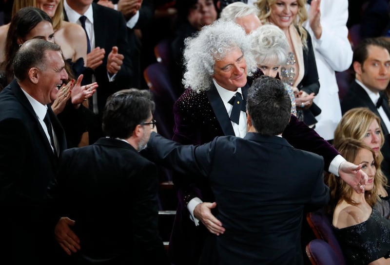 Brian May of Queen (C) congratulates Paul Massey, Tim Cavagin and John Casali after they won the Best Sound Mixing award for 'Bohemian Rhapsody.' Photo: Reuters