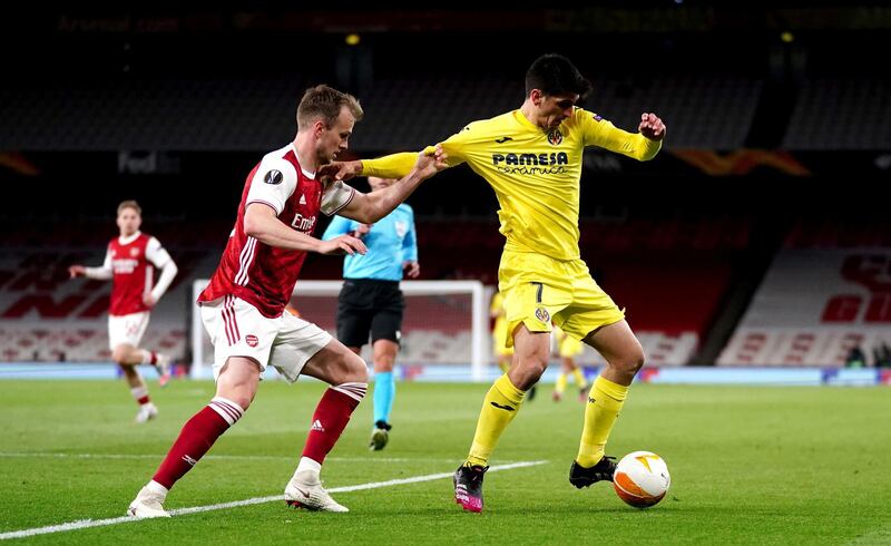 Arsenal's Rob Holding (left) and Villarreal's Moreno Gerard battle for the ball during the UEFA Europa League Semi Final at the Emirates Stadium, London. Picture date: Thursday May 6, 2021. PA Photo. See PA story SOCCER Arsenal. Photo credit should read: John Walton/PA Wire. RESTRICTIONS: Editorial use only, no commercial use without prior consent from rights holder.