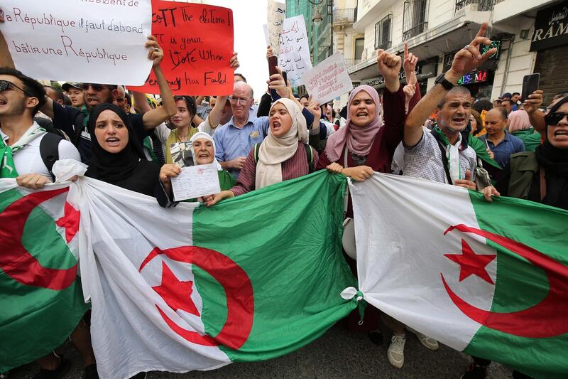Algerian protesters carrying national flags chant slogans during a students' demonstration against postponing the presidential elections in Algiers, Algeria. According to reports, Algeria will hold elections on 12 December, after the July vote was postponed, amid political vacuum since president Abdelaziz Bouteflika resigned.  EPA