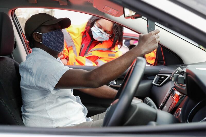 A man records himself as he receives a Covid-19 vaccine at a drive-thru vaccination centre at Batchwood Hall in St Albans. Reuters