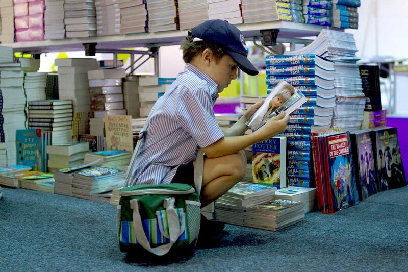 A primary school pupil browses selections at last year’s Sharjah Children’s Reading Festival at the Sharjah Expo Centre. Christopher Pike / The National

