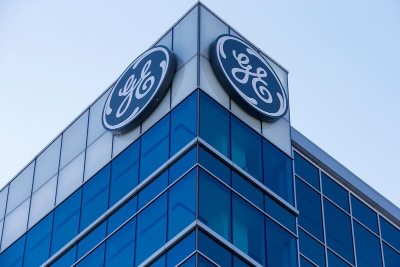 The General Electric logo is displayed at the top of their Global Operations Center, Tuesday, Jan. 16, 2018, in the Banks development of downtown Cincinnati. GE CEO John Flannery, who was put in charge of reviving the company last summer, revealed significant issues at GE Capital on Tuesday, which will lead to a $6.2 billion after-tax charge in the fourth quarter. (AP Photo/John Minchillo)