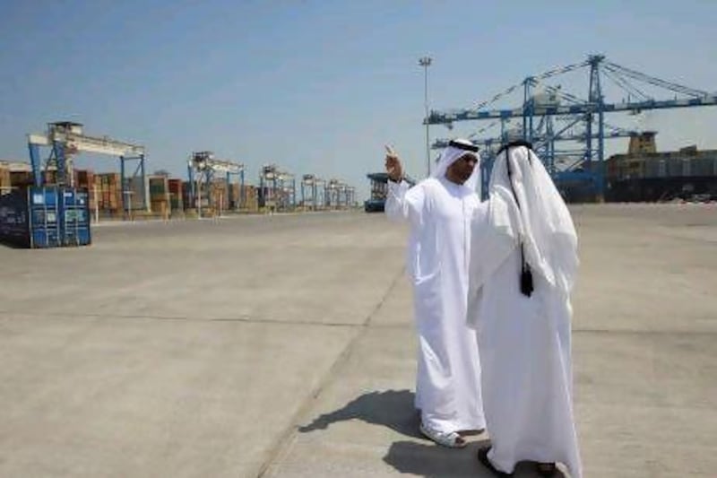 Sultan Ahmed Al Jaber, the chairman of Abu Dhabi Ports Company, left, tours the Khalifa Port Container Terminal on its opening day. Ravindranath K / The National