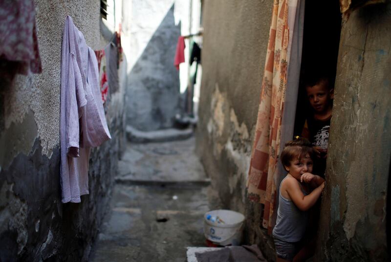 Palestinian children look out of their homes at Al-Shati refugee camp in Gaza City. Reuters