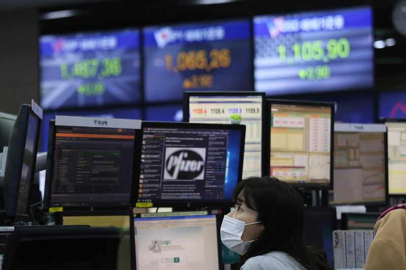 A currency trader watches monitors at the foreign exchange dealing room of the KEB Hana Bank headquarters in Seoul, South Korea, Thursday, Nov. 19, 2020. Asian stocks followed Wall Street lower on Thursday as anxiety about the economic fallout from rising coronavirus infections in the United States and Europe clashed with optimism about a possible vaccine. (AP Photo/Ahn Young-joon)