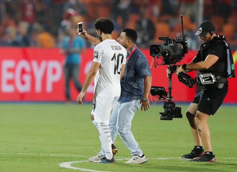 Egypt's Mohamed Salah poses for a selfie with a fan after the match. Reuters