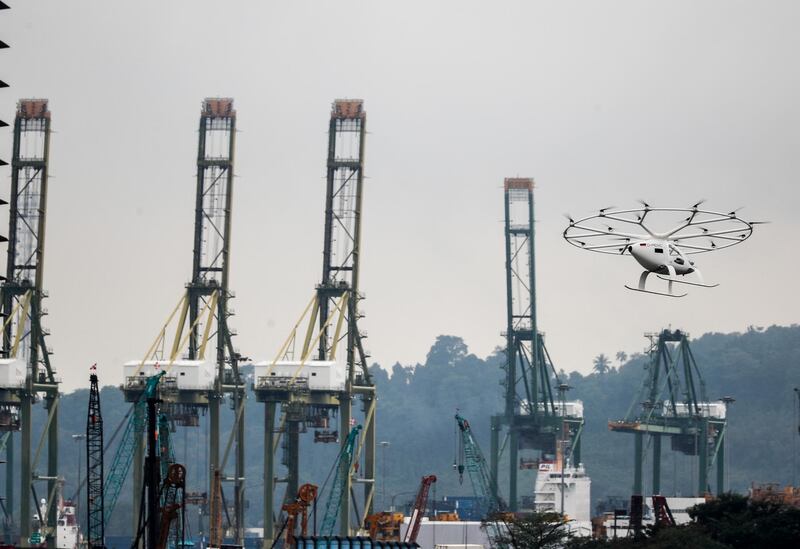 A Volocopter air taxi flies past a building during its test flight in Singapore. The Volocopter is a manned, electric powered multicopter. EPA