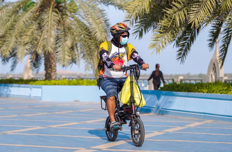 Abu Dhabi, United Arab Emirates, June 24, 2020.   
FOR:  Standalone / Stock Images
-- A man on his bike along the corniche during the Covid-19 pandemic.
Victor Besa  / The National
Section:  NA
Reporter:  none