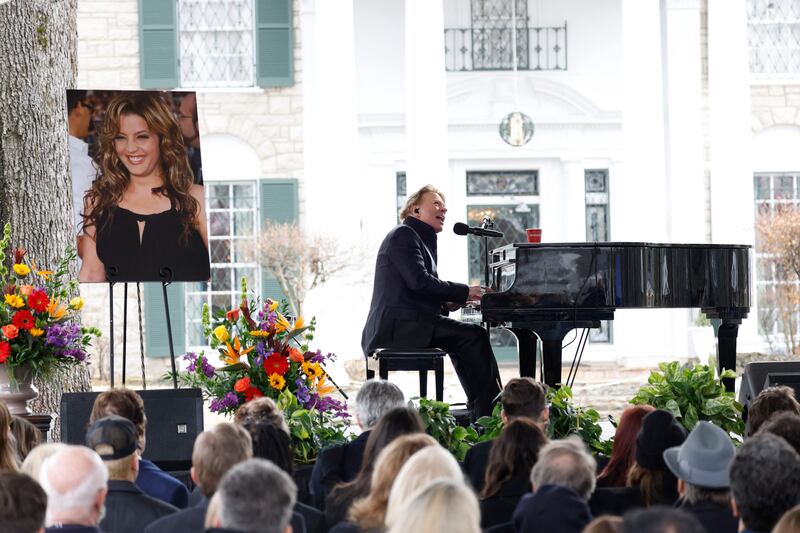 Axl Rose performs November Rain at the public memorial. Getty / AFP