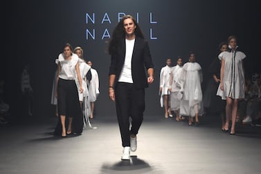 Nabil Nayal, walking the runway above at Fashion Forward in Dubai in 2017, has not been back to his Syrian birthplace in decades, but is returning to his roots via the country's rich textiles. Stuart C. Wilson/Getty Images for FFWD