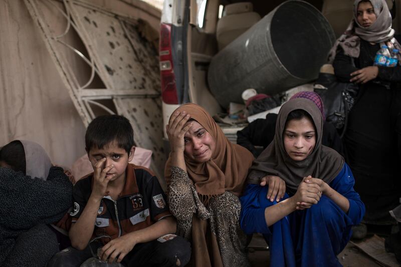 
                  <p>Fleeing Iraqi civilians sit inside a house as they wait to be taken out of the Old City during fighting between Iraqi forces and Islamic State militants in Mosul, Iraq, Saturday, July 8, 2017. (AP Photo/Felipe Dana)</p>
               