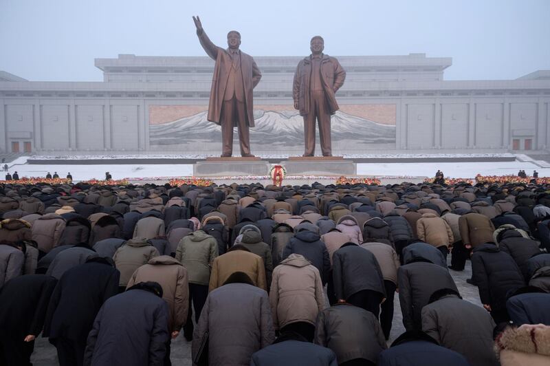 Pyongyang residents bow before the statues of late North Korean leaders Kim Il Sung and Kim Jong Il during National Memorial Day on Mansu Hill in Pyongyang. AFP