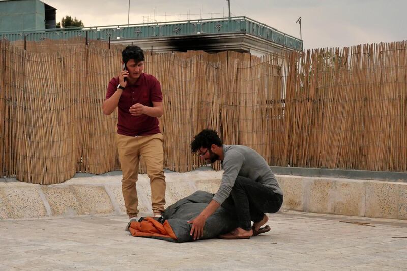 Pictured: Zabih Afzali and his friend wrap up a sleeping bag together on the roof terrace of an office in Kabul. They are preparing for a mountain expedition in Bamyan over the Eid holiday. 
Photo by Charlie Faulkner
May 2021