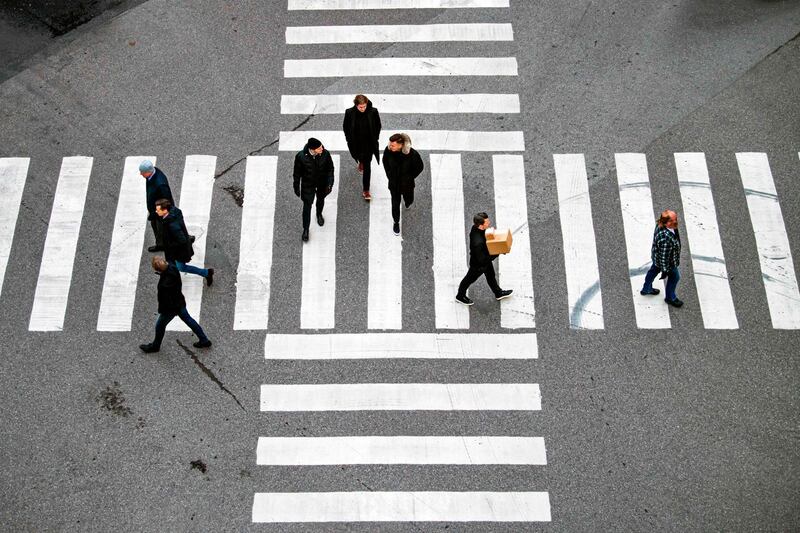 Pedestrians cross an intersection in the heart of Stockholm. AFP