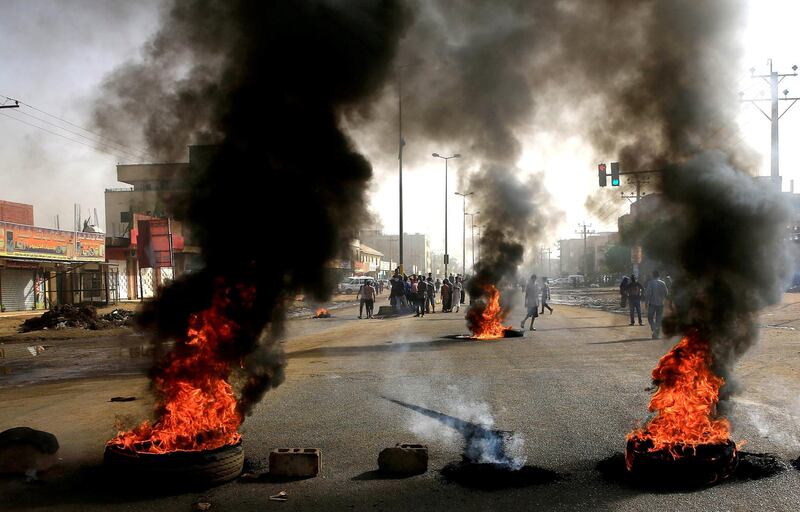 Sudanese protesters use burning tyres to erect a barricade on a street, demanding that the country's Transitional Military Council hand over power to civilians, in Khartoum. REUTERS