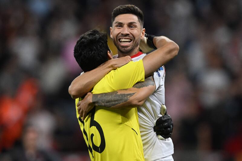 Bono celebrates with Gonzalo Montiel, who struck the winning penalty for Sevilla. AFP