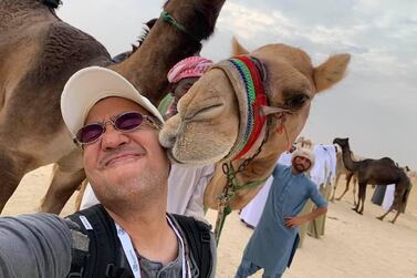 The National's Victor Besa gets a wet kiss on the face from a beauty contestant at Al Dhafra festival. Victor Besa / The National